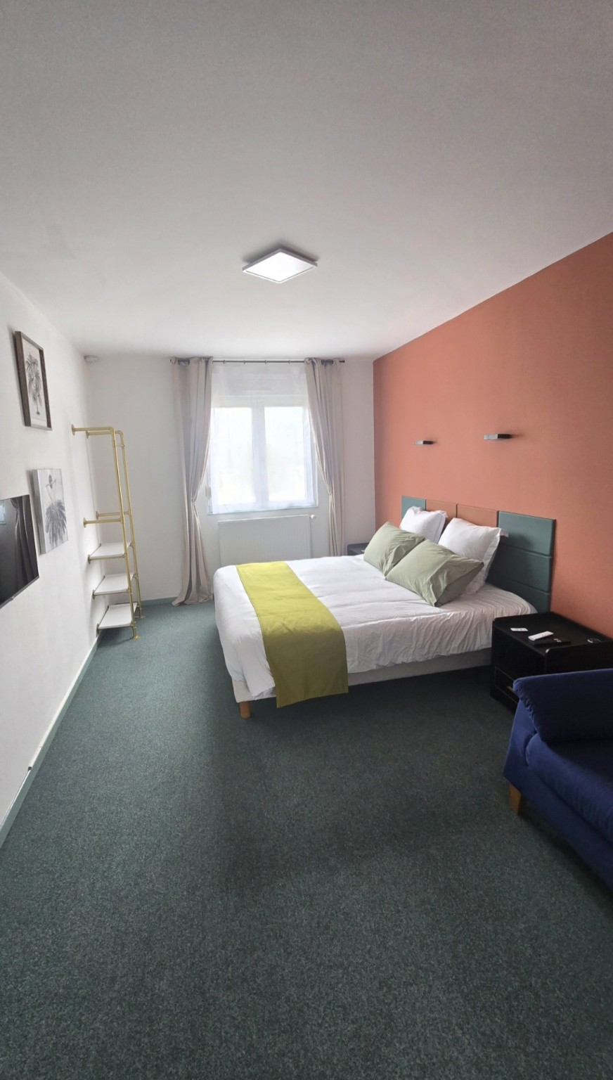 Pièce principale lumineuse de l’Appartement 2 avec lit king size et canapé