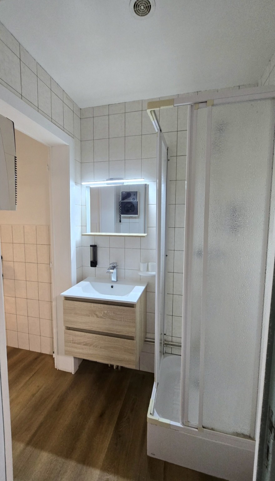 Salle d’eau privative de l’Appartement 2 avec douche et meuble vasque